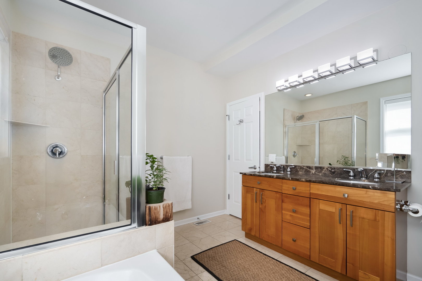 4826 North Winthrop Avenue, Unit 2S Chicago, IL 60640 - Photo 12 of 21 a spacious bathroom with a granite countertop sink a mirror and a shower