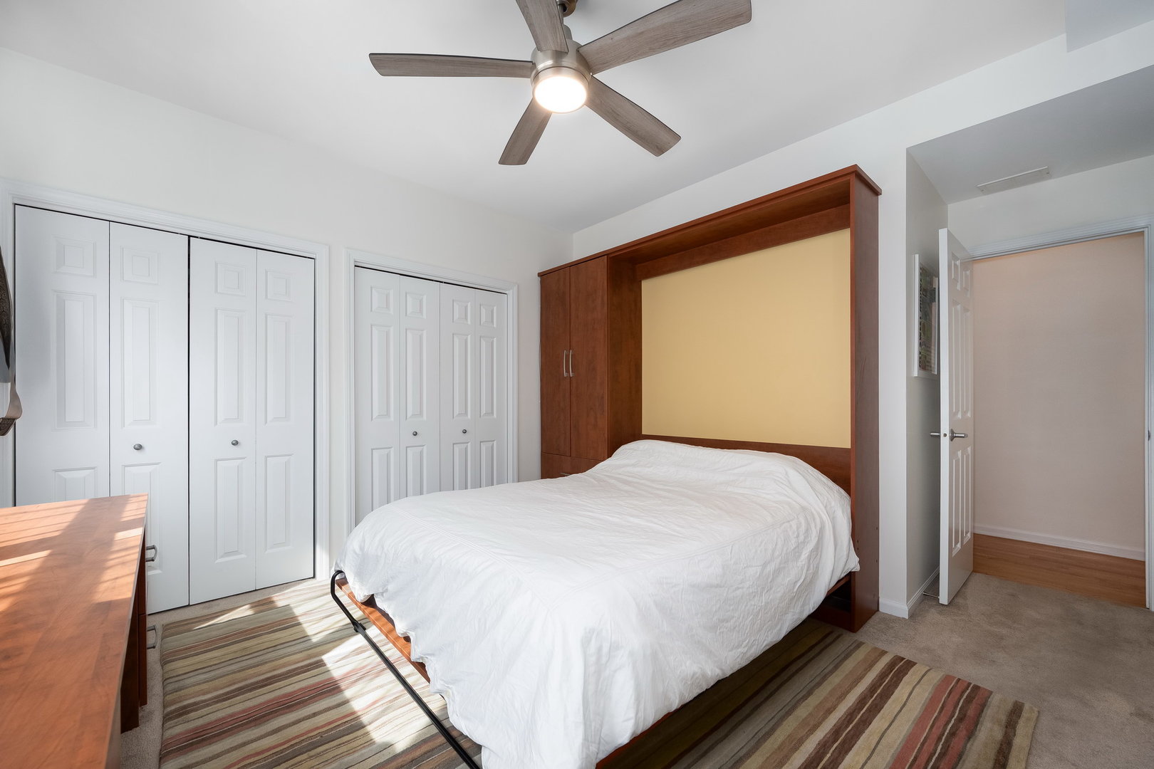 4826 North Winthrop Avenue, Unit 2S Chicago, IL 60640 - Photo 15 of 21 a bedroom with a bed and a chandelier
