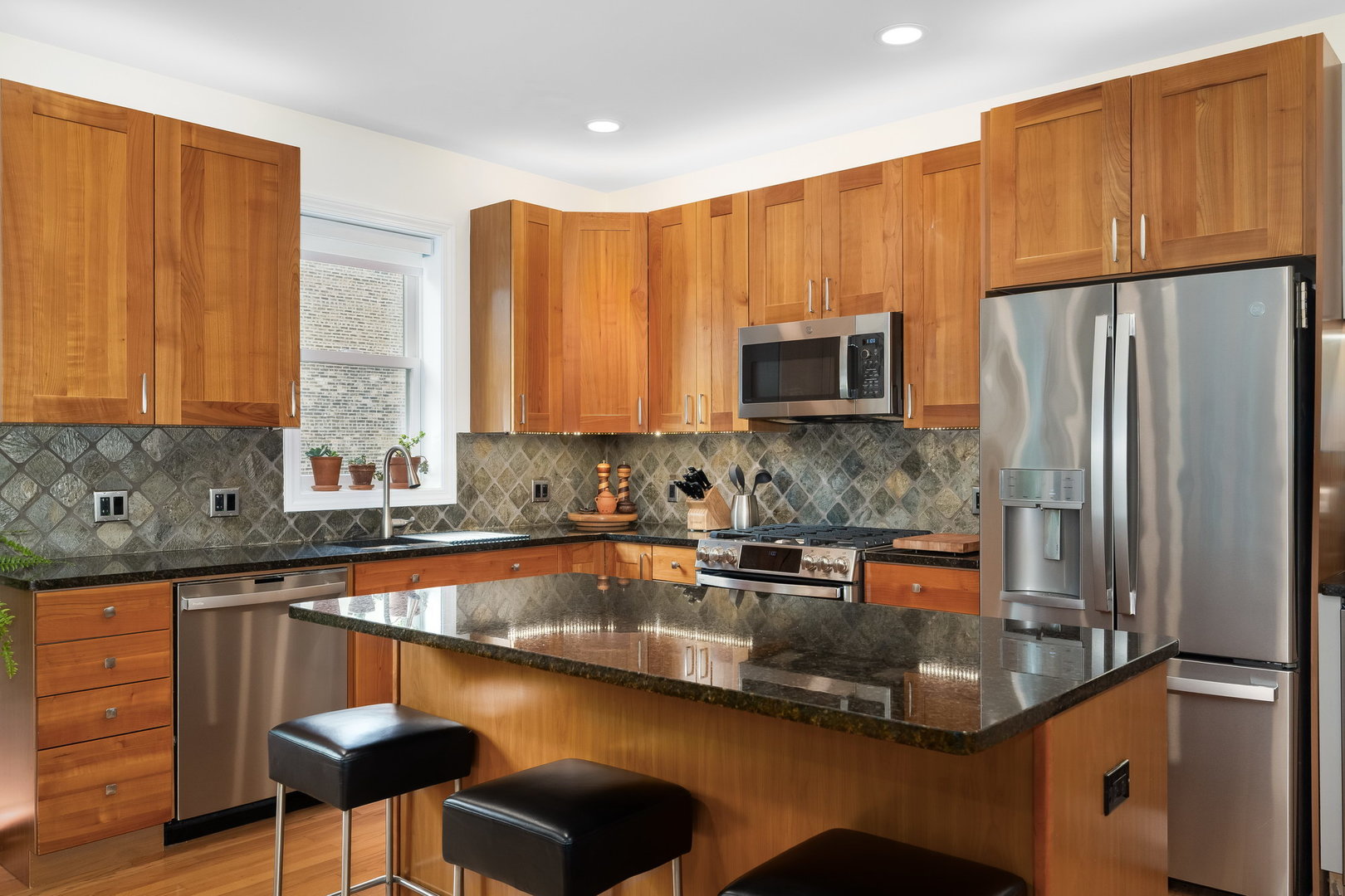 4826 North Winthrop Avenue, Unit 2S Chicago, IL 60640 - Photo 7 of 21 a kitchen with stainless steel appliances granite countertop a sink refrigerator and microwave