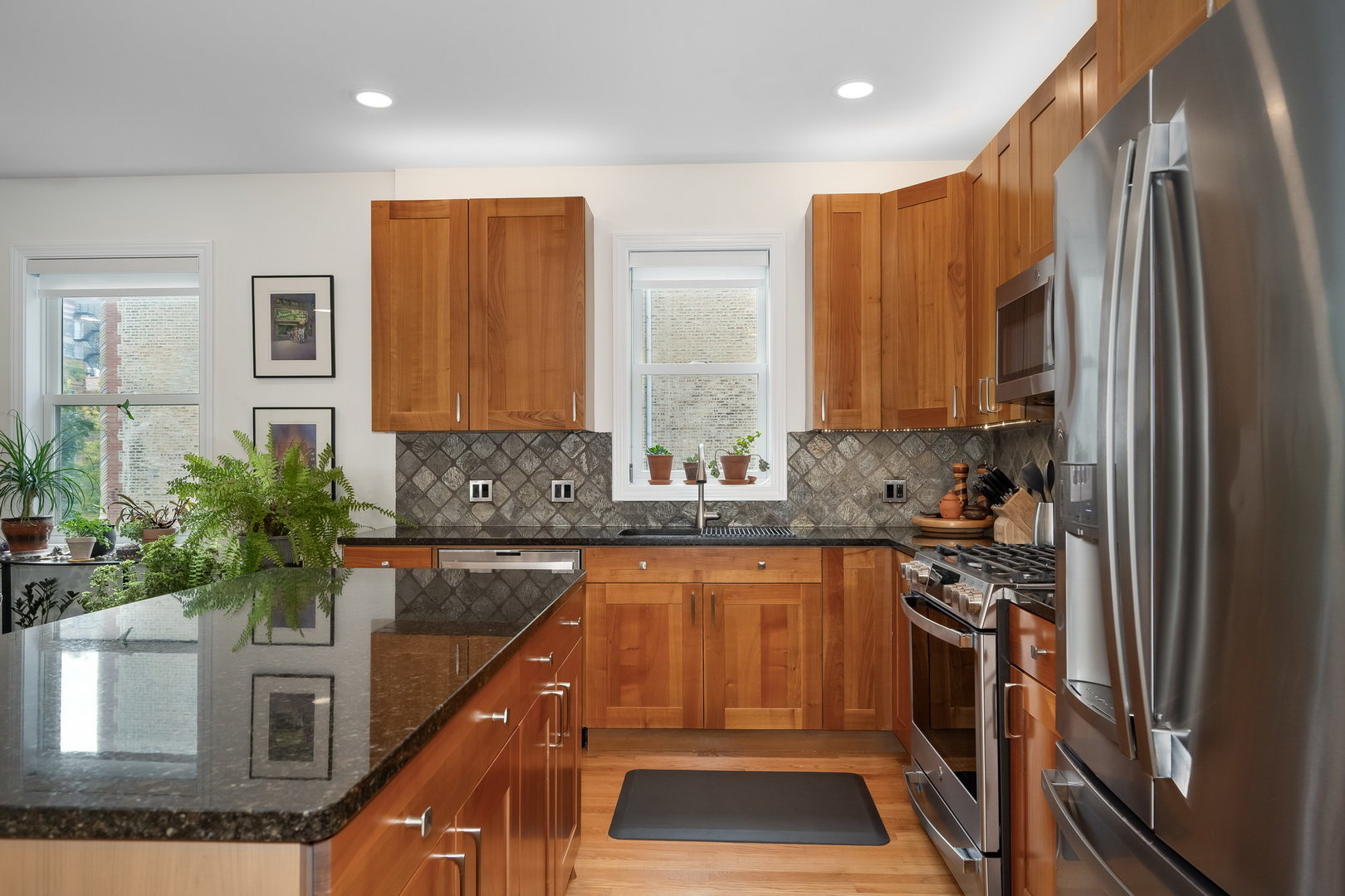 4826 North Winthrop Avenue, Unit 2S Chicago, IL 60640 - Photo 9 of 21 a kitchen with stainless steel appliances granite countertop a stove a sink and a refrigerator