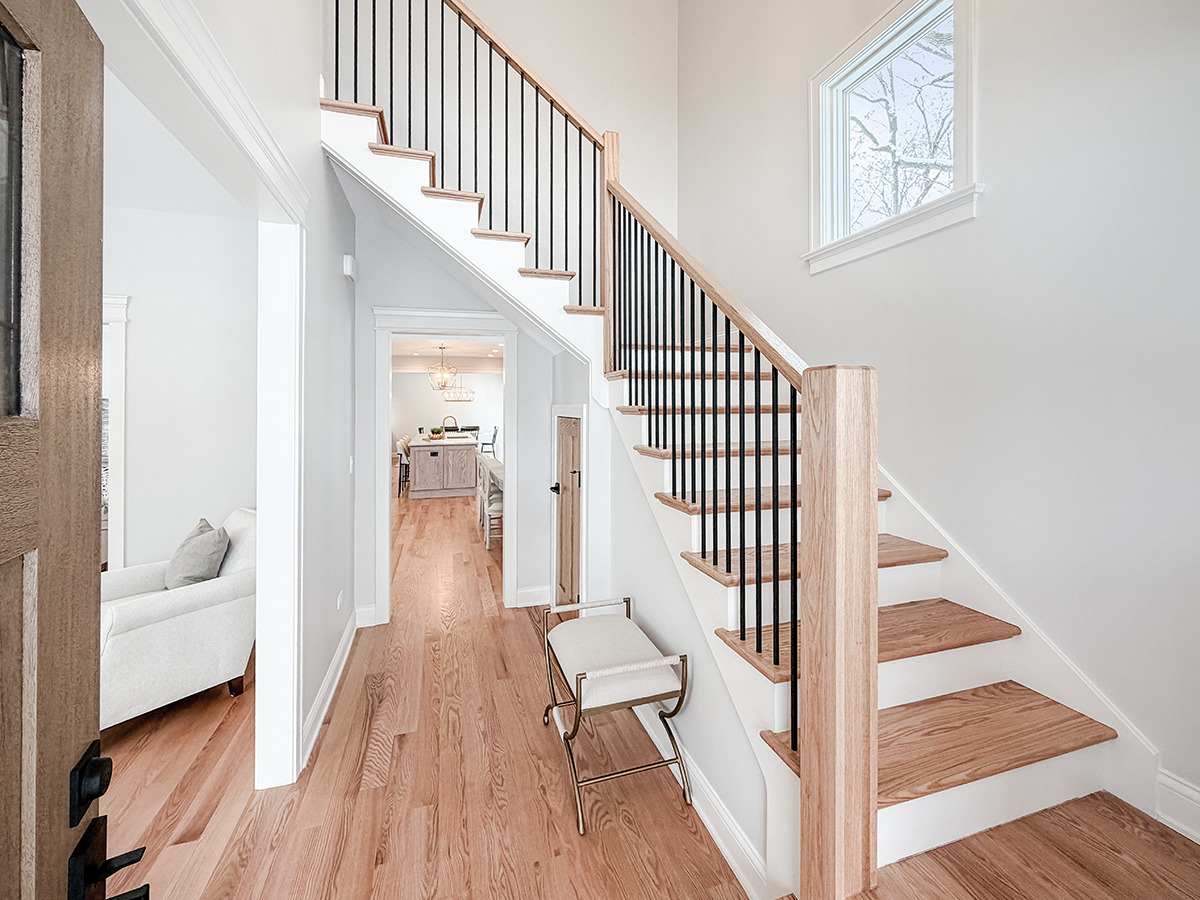 885 Geneva Road St. Charles, IL 60174 - Photo 5 of 62 a view of a hallway with wooden floor and staircase