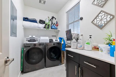 a utility room with sink dryer and washer
