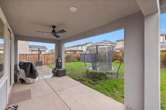 a view of a chair and table in backyard of the house
