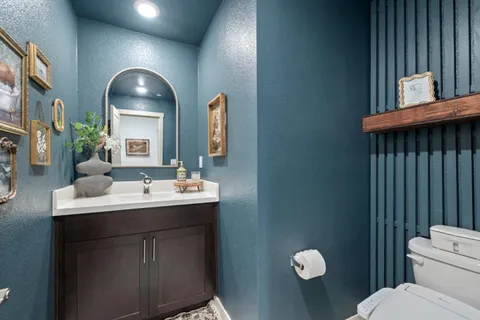 a bathroom with a toilet sink and mirror