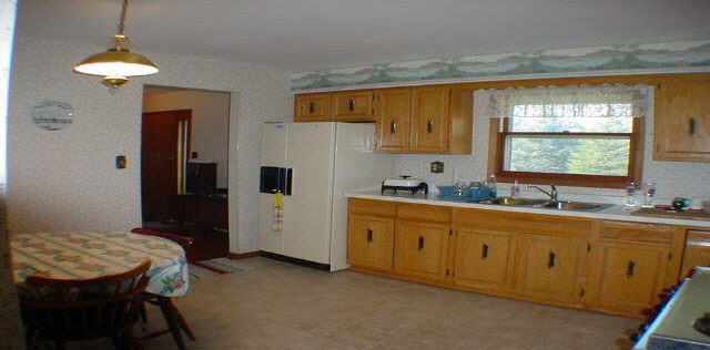 6645 Simpson Road Rockford, IL 61102 - Photo 3 of 6 a kitchen with sink cabinets and window