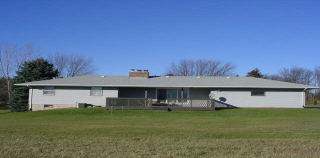 6645 Simpson Road Rockford, IL 61102 - Photo 6 of 6 a front view of a house with a garden and trees