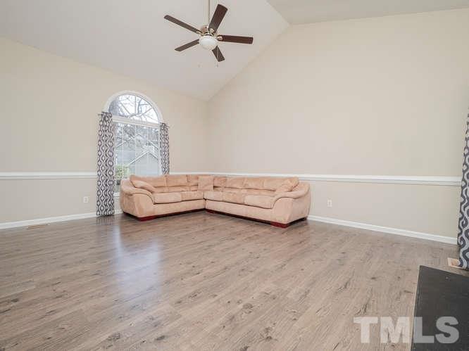 5520 Edgebury Road Raleigh, NC 27613 - Photo 12 of 29 a living room with furniture and a wooden floor