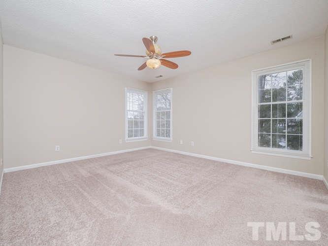 5520 Edgebury Road Raleigh, NC 27613 - Photo 14 of 29 an empty room with windows and fan