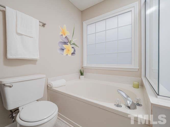 5520 Edgebury Road Raleigh, NC 27613 - Photo 16 of 29 a white toilet sitting next to a bath tub