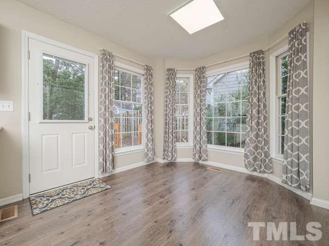 5520 Edgebury Road Raleigh, NC 27613 - Photo 8 of 29 a view of an empty room with wooden floor and a window
