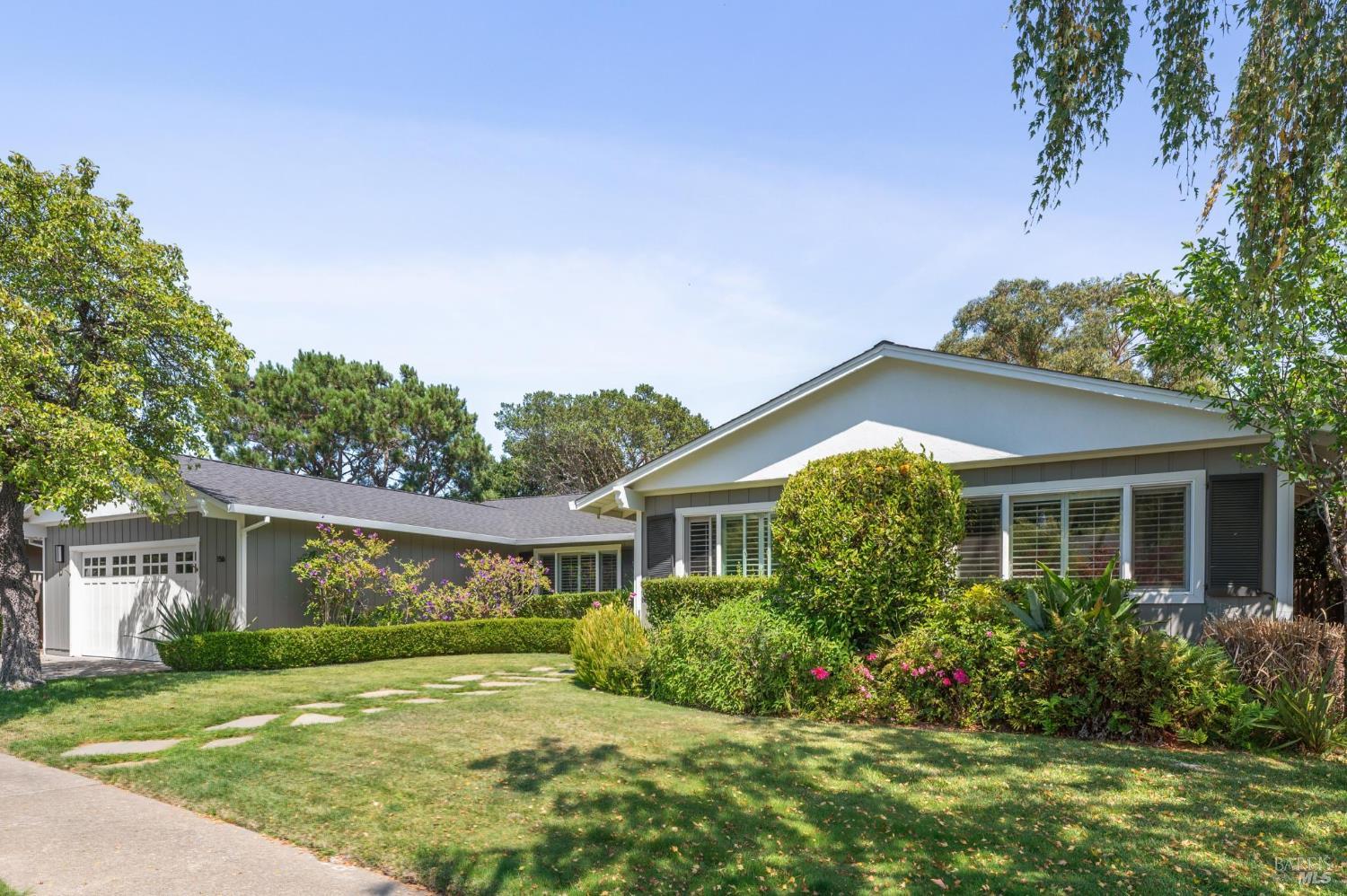 a view of a house with garden and yard