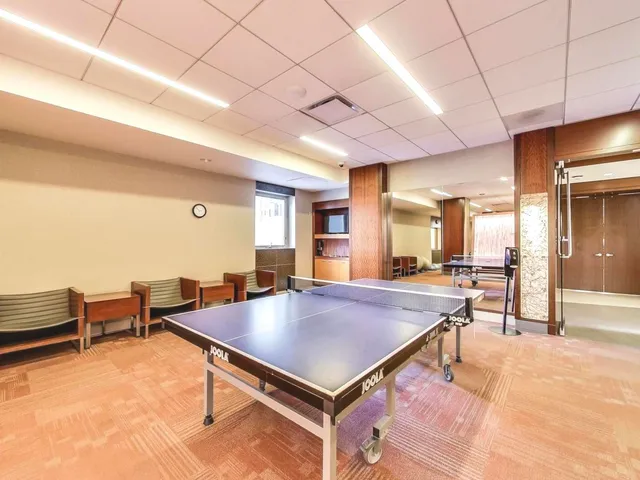 a room with pool table and windows
