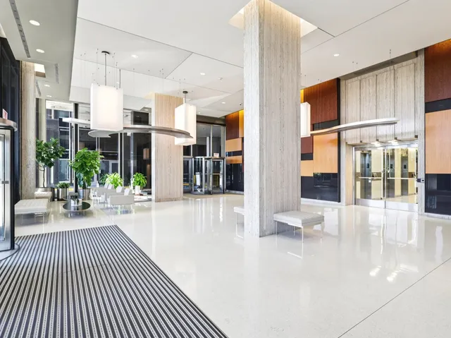 a lobby with furniture and large windows