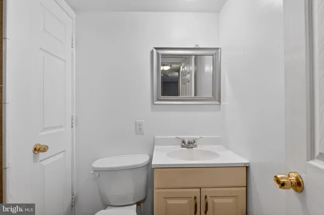 a bathroom with a sink toilet and vanity