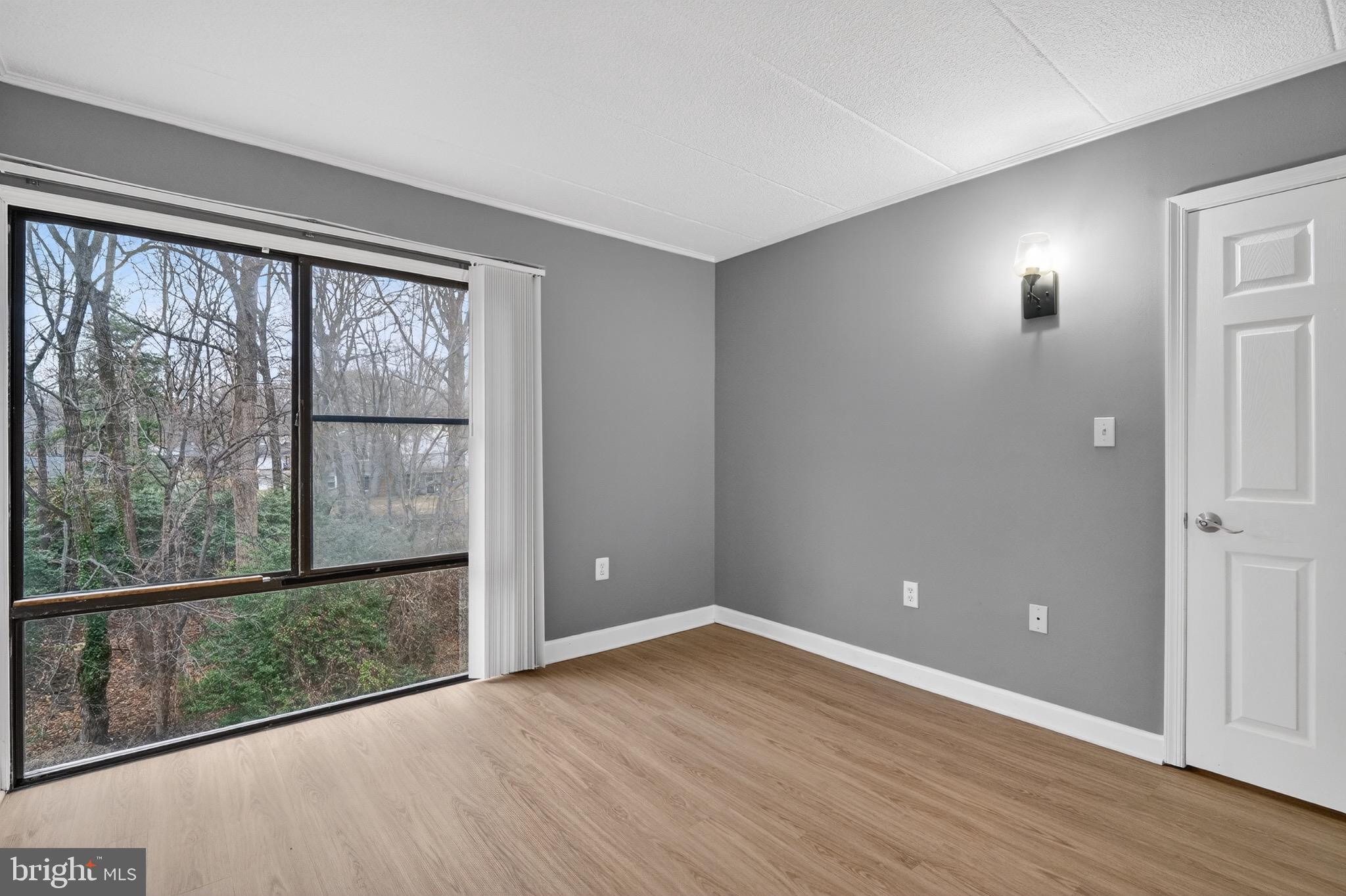 3301 Hewitt Avenue, Unit 403 Silver Spring, MD 20906 - Photo 18 of 19 wooden floor in an empty room with a window