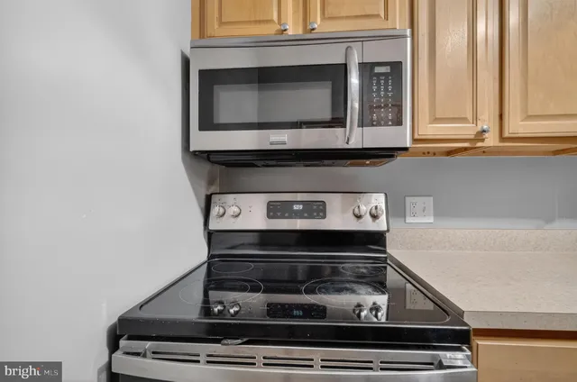 a stove top oven sitting inside of a kitchen