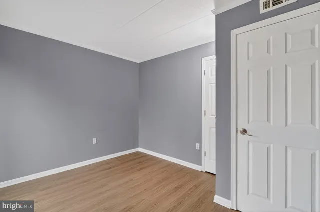 a view of an empty room with wooden floor