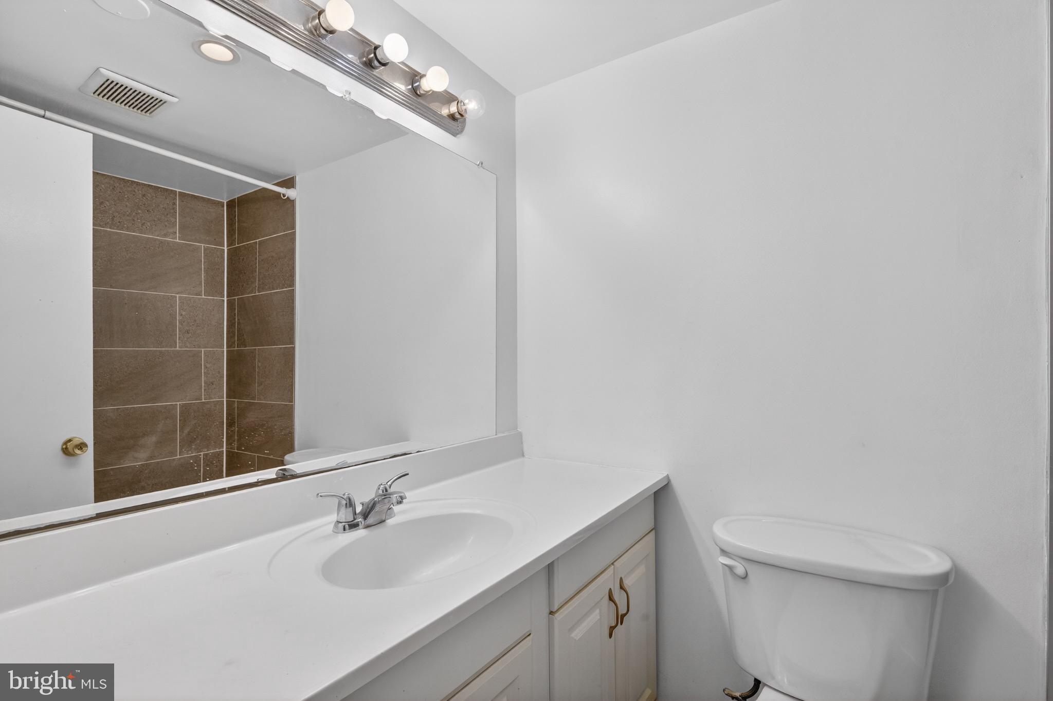 3301 Hewitt Avenue, Unit 403 Silver Spring, MD 20906 - Photo 10 of 19 a bathroom with a sink a toilet and shower