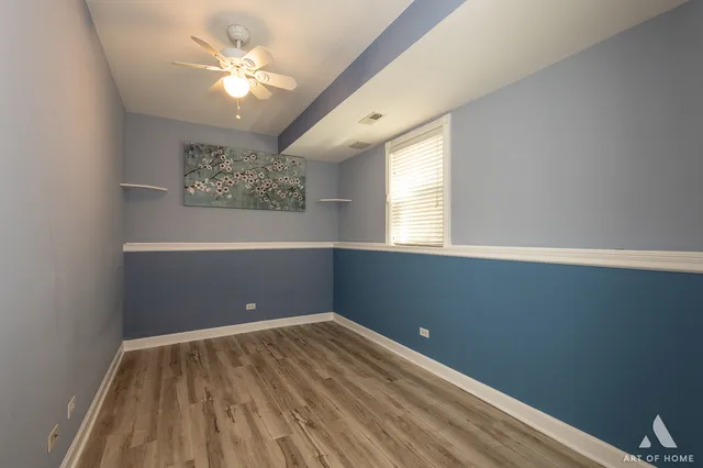 a view of empty room with window and fan