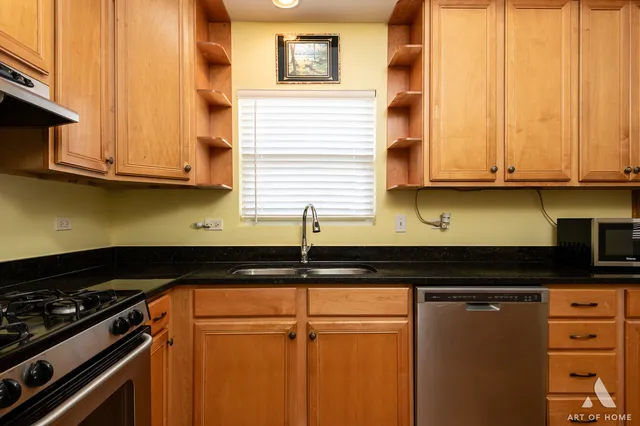 a kitchen with granite countertop cabinets and black appliances