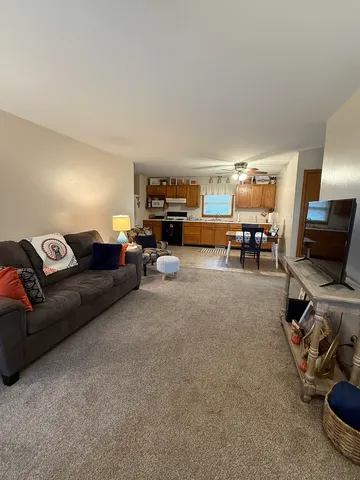 a living room with furniture a flat screen tv and a couch