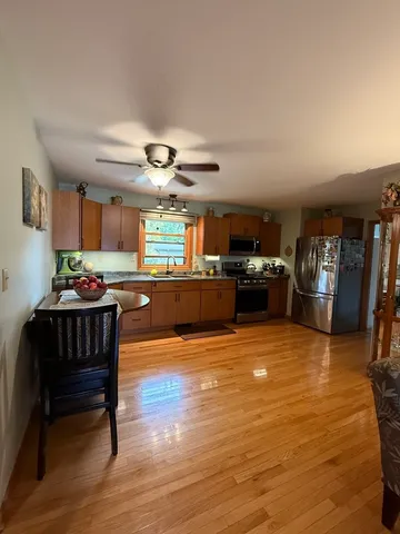 a living room with furniture and kitchen view