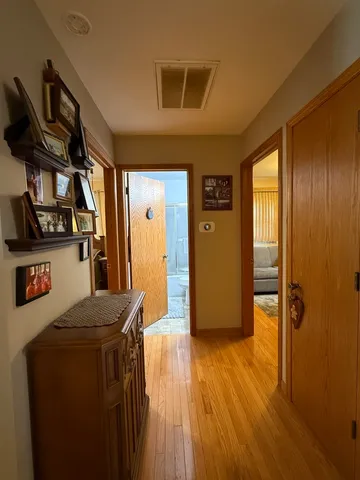 a view of hallway with wooden floor and stairs