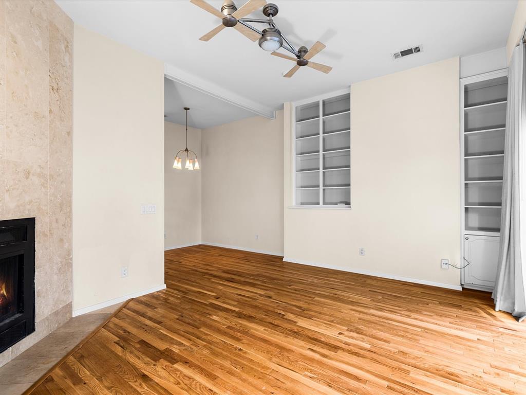 4110 Travis Street, Unit E Dallas, TX 75204 - Photo 12 of 23 a view of empty room with wooden floor and fan