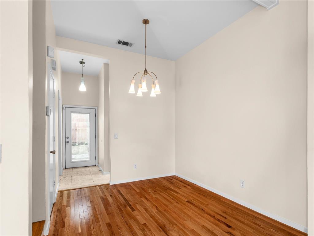 4110 Travis Street, Unit E Dallas, TX 75204 - Photo 13 of 23 a view of empty room with wooden floor and fan