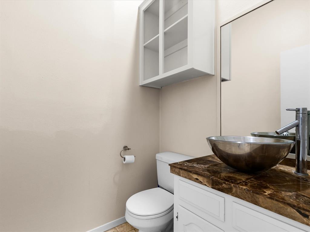 4110 Travis Street, Unit E Dallas, TX 75204 - Photo 16 of 23 a bath room with a toilet and a sink