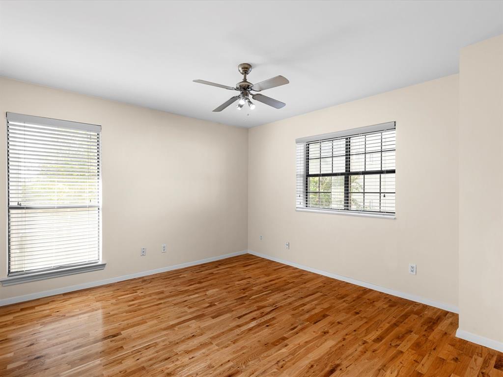 4110 Travis Street, Unit E Dallas, TX 75204 - Photo 19 of 23 wooden floor in an empty room with a window