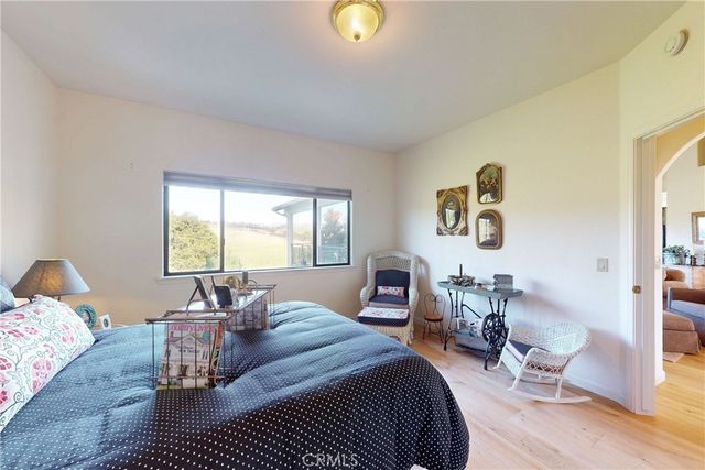 a bedroom with furniture and a large window