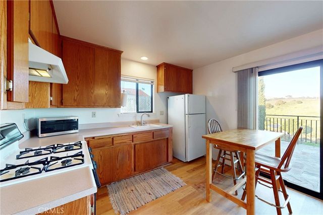 a roof deck with table and chairs