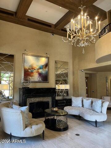 7181 East Camelback Road, Unit 201 Scottsdale, AZ 85251 - Photo 13 of 15 a living room with furniture a chandelier and a fireplace
