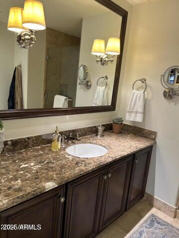 7181 East Camelback Road, Unit 201 Scottsdale, AZ 85251 - Photo 3 of 15 a bathroom with a granite countertop sink and a mirror