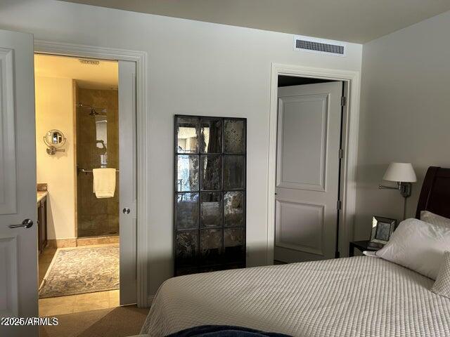 7181 East Camelback Road, Unit 201 Scottsdale, AZ 85251 - Photo 6 of 15 a bedroom with a bed and glass door
