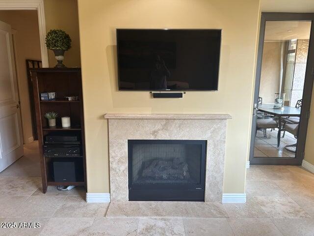 7181 East Camelback Road, Unit 201 Scottsdale, AZ 85251 - Photo 9 of 15 a living room with a fireplace and a flat screen tv