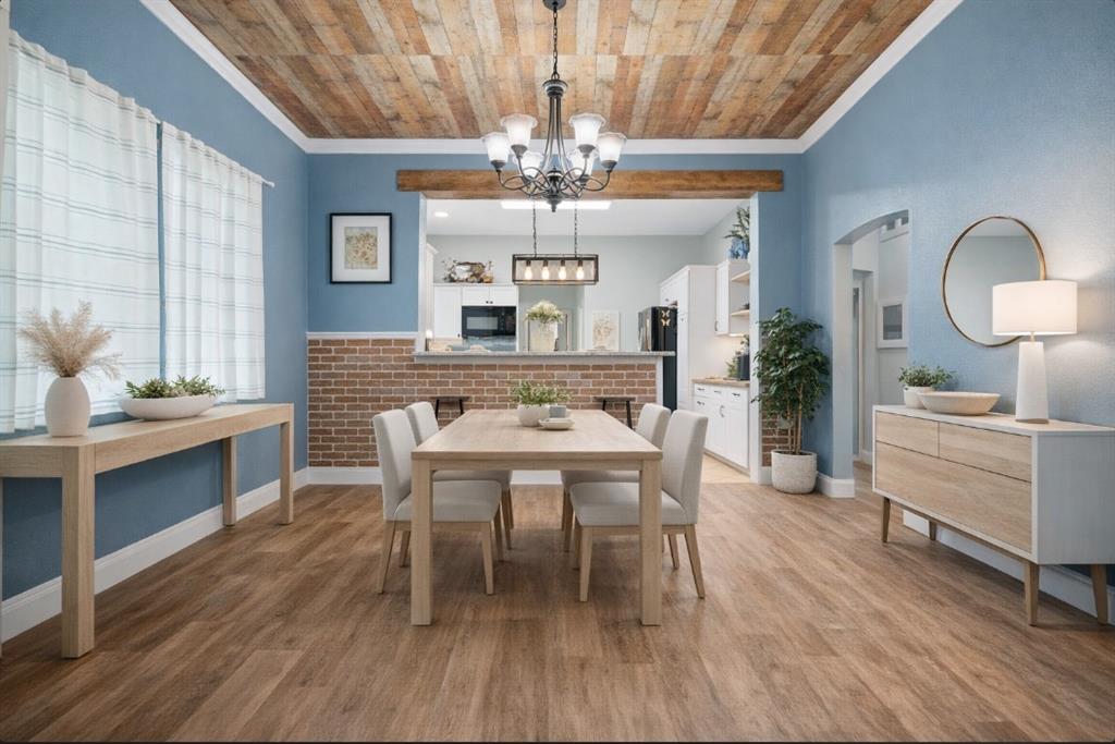 809 Southwest 5th Avenue Mineral Wells, TX 76067 - Photo 4 of 18 a dining room with wooden floor a chandelier a wooden table and chairs