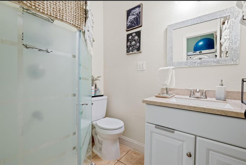 809 Southwest 5th Avenue Mineral Wells, TX 76067 - Photo 8 of 18 a bathroom with a toilet a sink and mirror