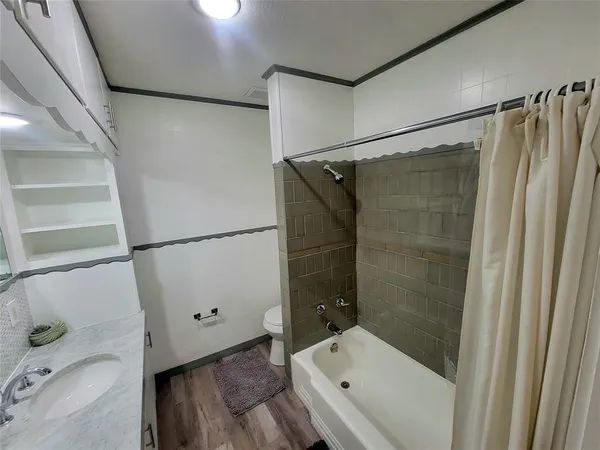 a bathroom with a tub a sink and a shower