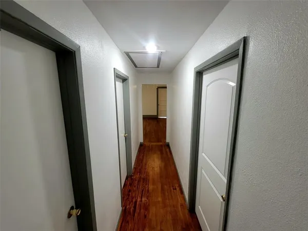 a view of hallway with wooden floor