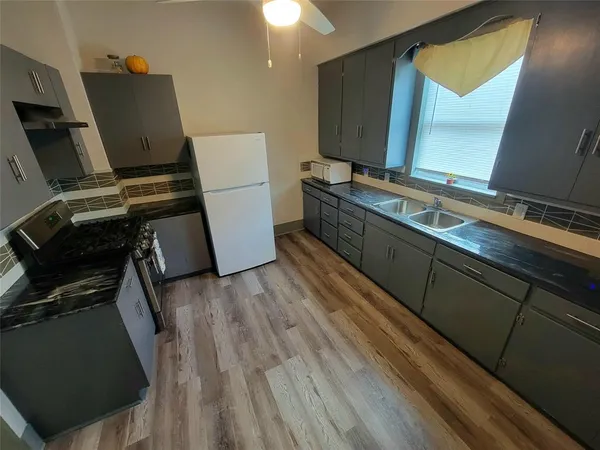 a room with wooden floor and cabinets