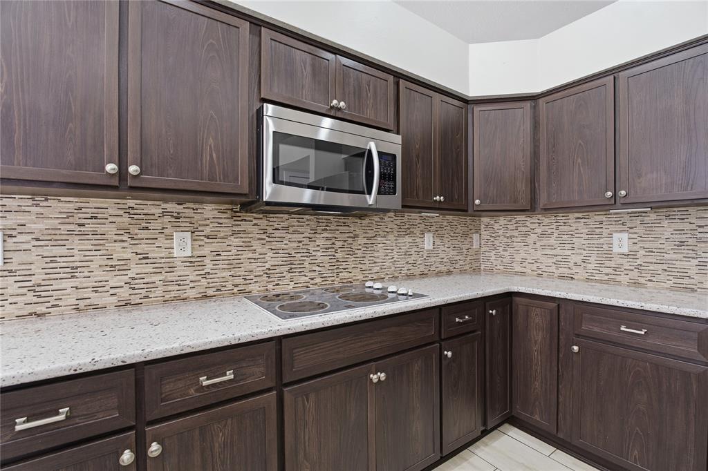17431 Isbell Lane Odessa, FL 33556 - Photo 13 of 47 a kitchen with stainless steel appliances granite countertop wooden cabinets a granite counter top and a sink