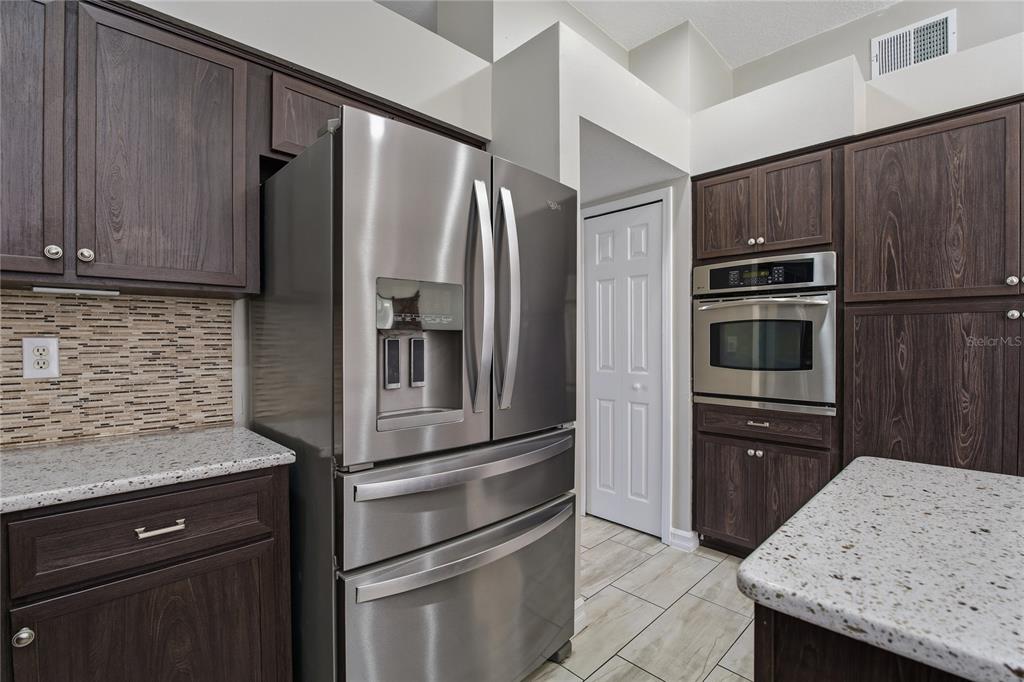 17431 Isbell Lane Odessa, FL 33556 - Photo 14 of 47 a kitchen with granite countertop stainless steel appliances and refrigerator