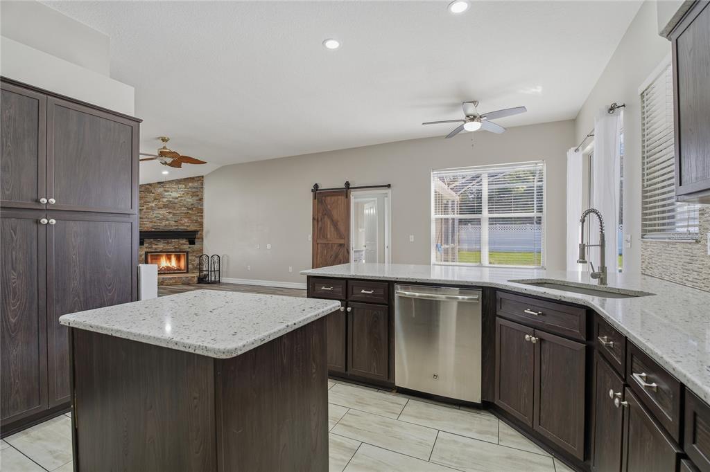 17431 Isbell Lane Odessa, FL 33556 - Photo 15 of 47 a kitchen with a sink refrigerator and cabinets
