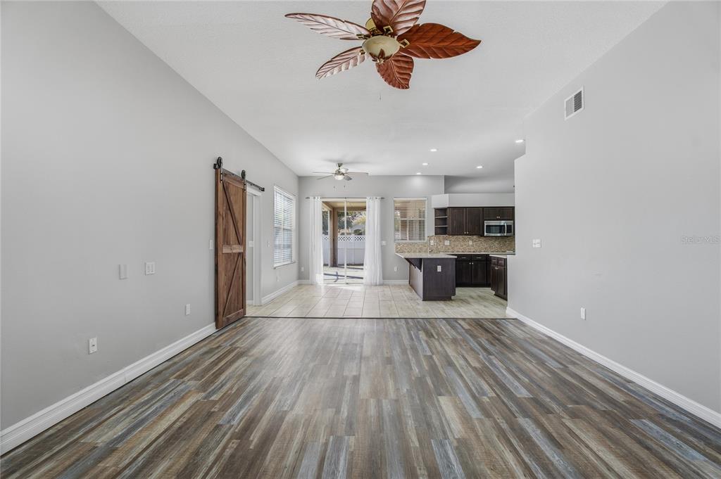17431 Isbell Lane Odessa, FL 33556 - Photo 18 of 47 a view of a room with kitchen island stainless steel appliances wooden floor and window