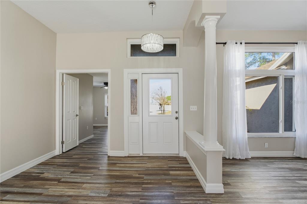 17431 Isbell Lane Odessa, FL 33556 - Photo 2 of 47 a view of a hallway with wooden floor and staircase