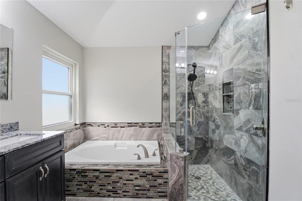 17431 Isbell Lane Odessa, FL 33556 - Photo 23 of 47 a bathroom with a bathtub and shower