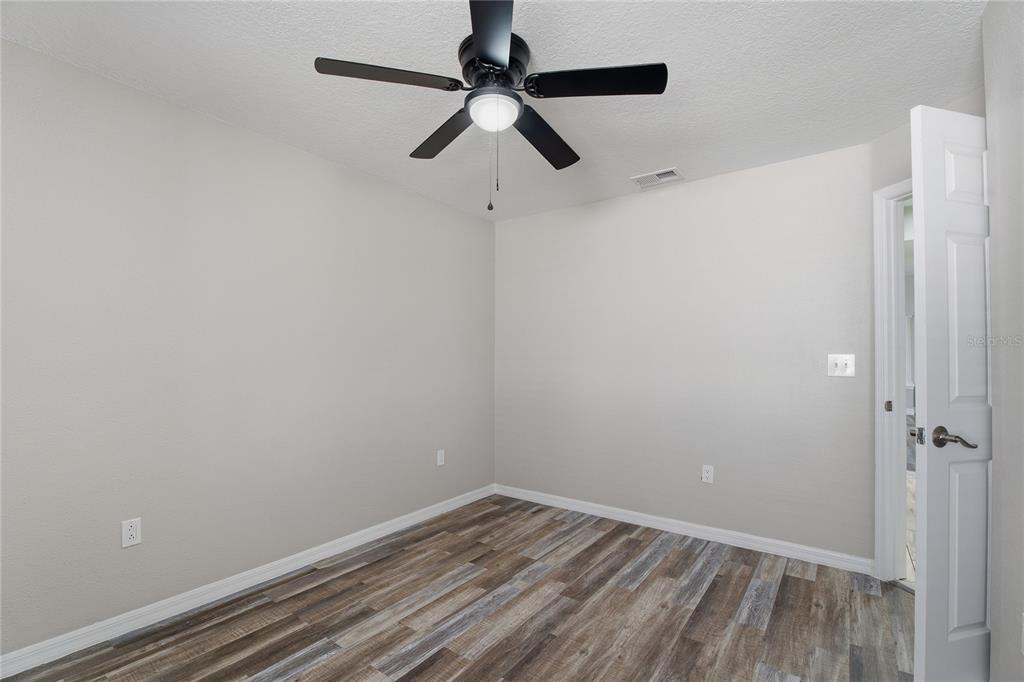 17431 Isbell Lane Odessa, FL 33556 - Photo 29 of 47 a view of a room with wooden floor closet and ceiling fan