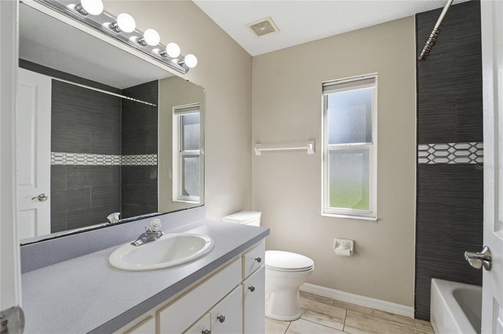 17431 Isbell Lane Odessa, FL 33556 - Photo 35 of 47 a bathroom with a sink vanity granite and toilet
